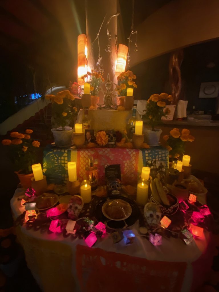 day of the dead altar lit by candles